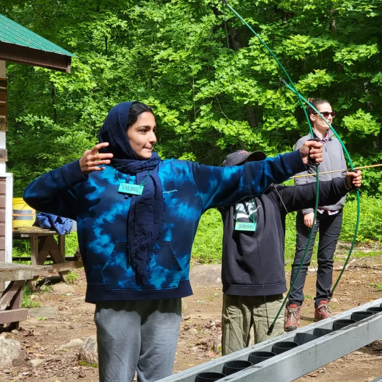 An archer's hand position suggests they just released an arrow