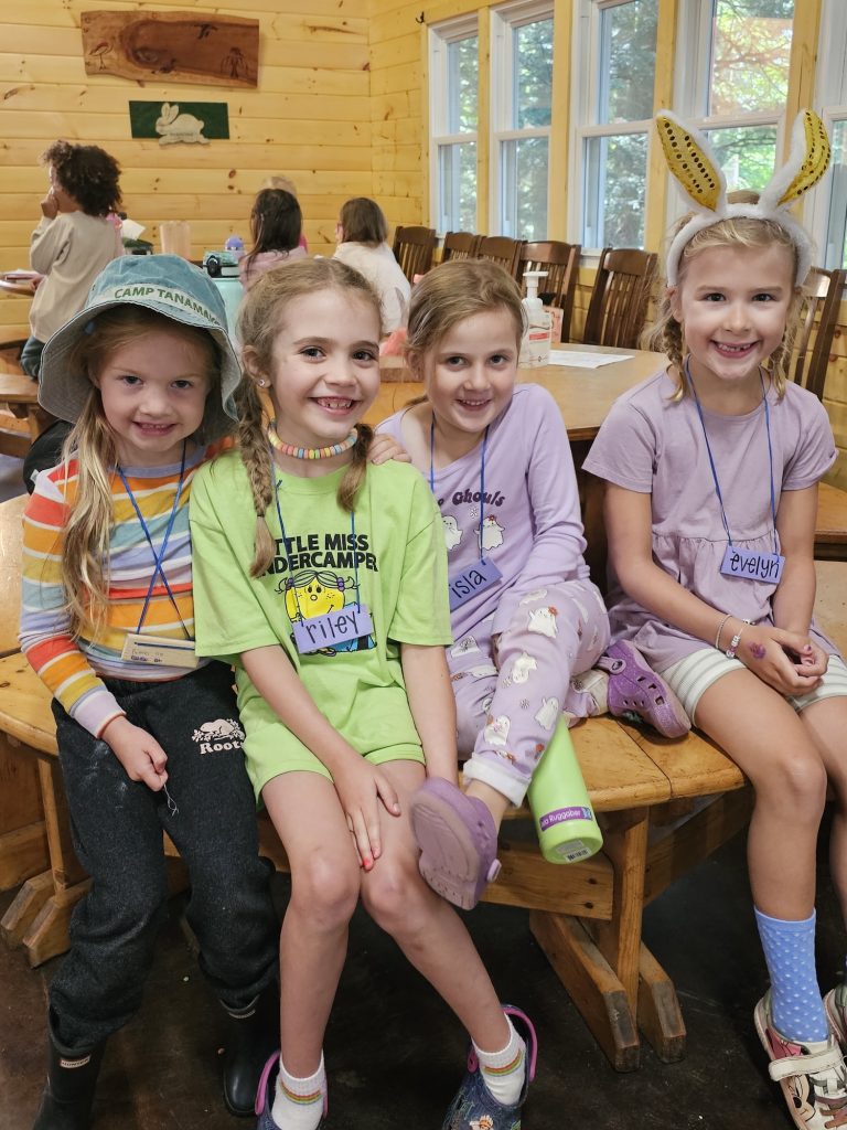 A group of four children with their faces painted white