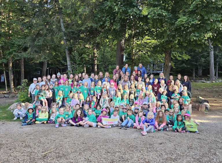 A large group photo of kids wearing turquoise t-shirts