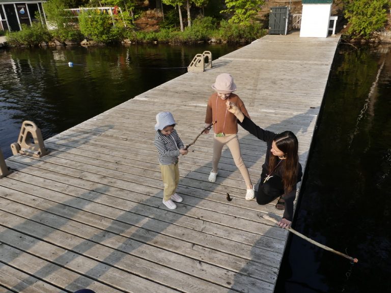Three young people on a sunny dock