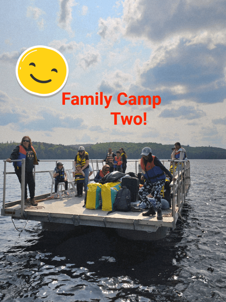A group of people gathered on a floating dock, with a smiling emoji and the caption "Family Camp Two!"